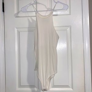 CRR medium white ribbed bodysuit. Double snap buttons. Elastic shoulder piece.